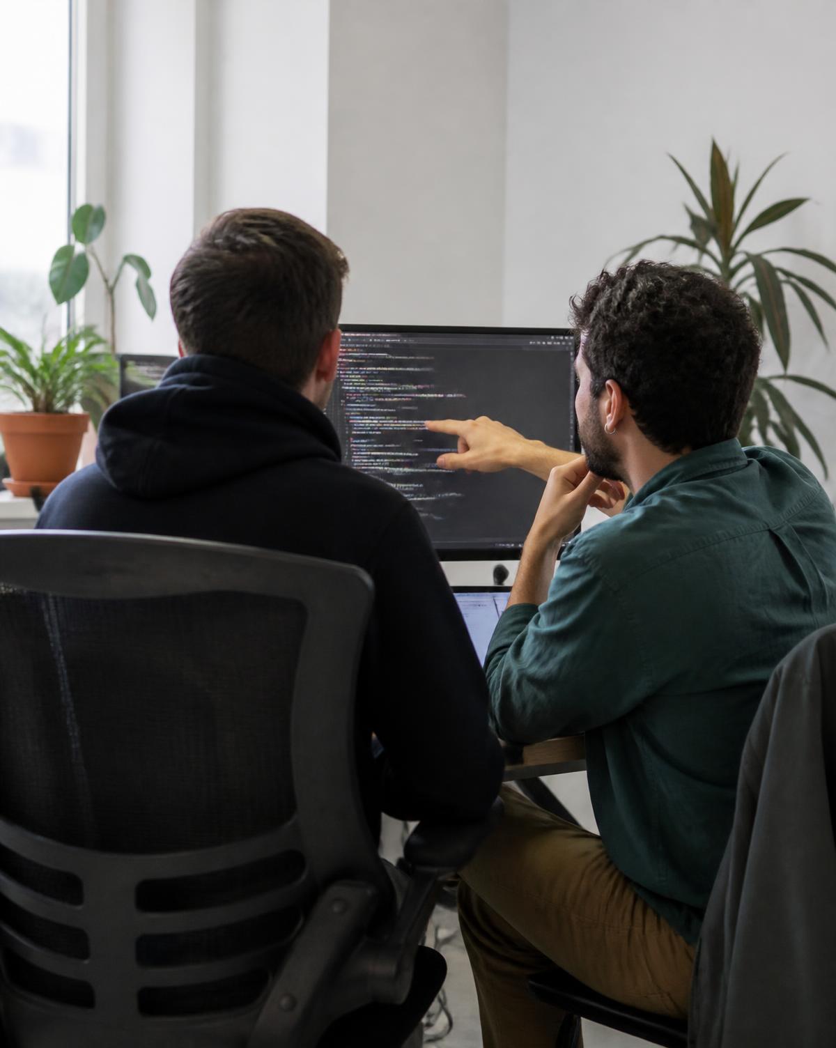 Two Alabama engineers reviewing code together